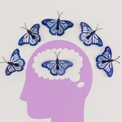 Human head surrounded by butterflies