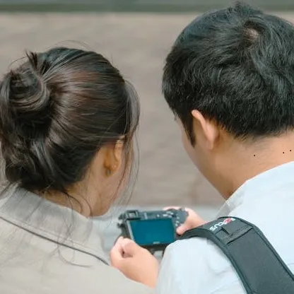 Two people looking at a small screen