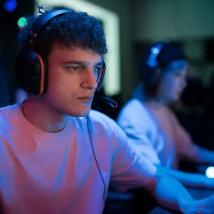 Man with headphones looking at a screen